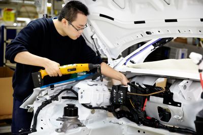 Operator using BCV nutrunner on car assembly in China