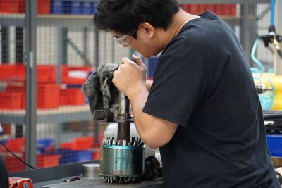 Man servicing a pump for factory overhaul
