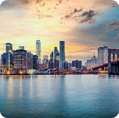 A wide view of a city with skyscrapers in the sunset