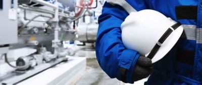 man worker helmet safety gloves industry plant