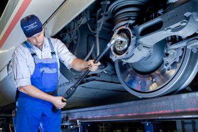 Worker with STwrench at Deutsche Bahn, ?Germany, maintaining running gears of ICE trains,?application,?people