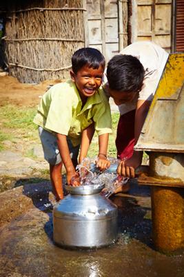 Boys playing with water in India