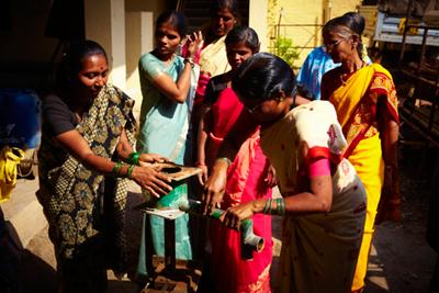 Women learning how to maintain the new water source
