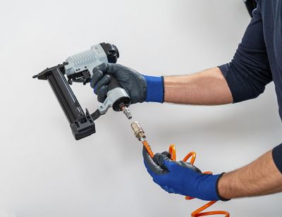 Man with Air Nailer and Air Stapler for DIY applications_squared