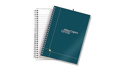 Teal colored cover of a notebook with Group branding 