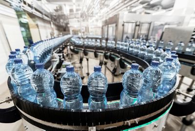 Modern production line with plastic bottles with water in factory.