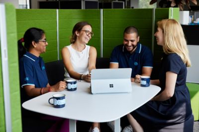 people around table with PC