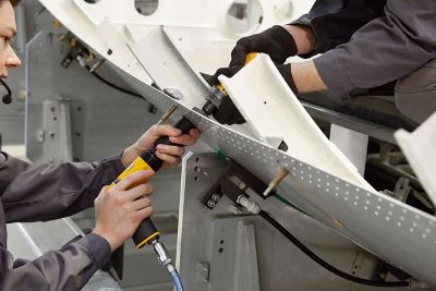 Two people using pneumatic tools