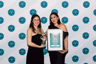 Two women smiling at awards ceremony