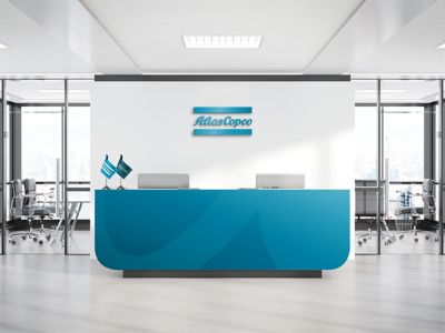 Reception branding with a logotype cutout on the desk in blue