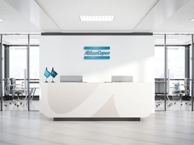 Reception branding with a logotype cutout on the desk in white