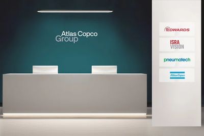 Reception area in Atlas Copco Group branding with additional brands displayed on the wall.