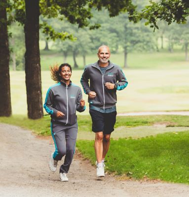 Two Atlas Copco employees running in nature