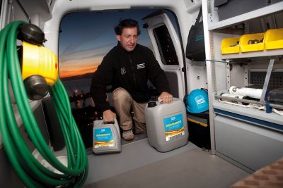 Service Technician handling lubricants in service van