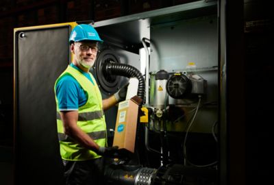 Technician servicing competitor machine with UNI parts