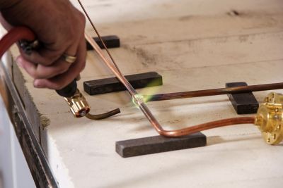 On site image of a technician soldering.