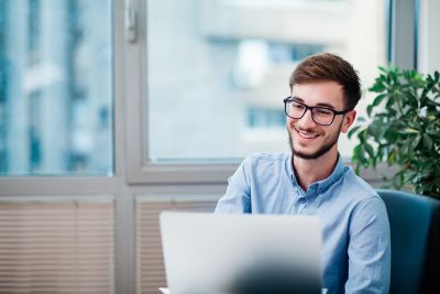 Young businessman in office working on laptop