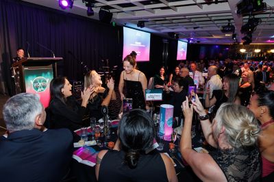 Table of people congratulating women standing