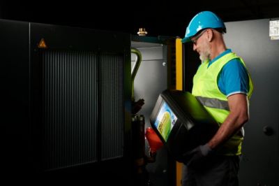 echnician Servicing Competitor Machine with UNI oil