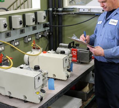 Man servicing rotary vane pumps 