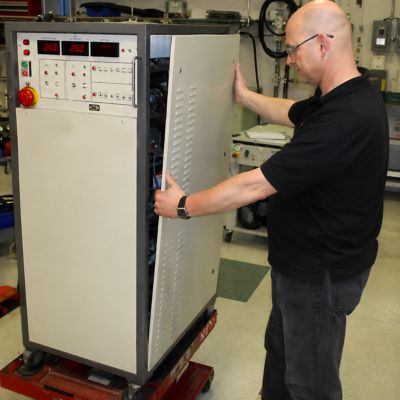 man servicing and reassembling a chiller unit