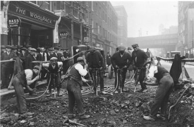 Historical image of men working on the streets of London using Atlas Copco equipment