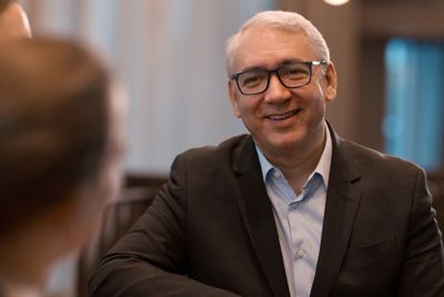 Photo of CEO Vagner Rego talking with colleagues