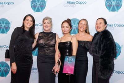 Group of women smiling at awards ceremony