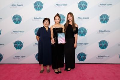 Three women smiling at awards ceremony