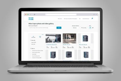 An image of a opened laptop with Atlas Copco photo and video gallery website visible on the screen