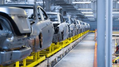 Modern automobile production line, automated production equipment. Shop for the Assembly of new modern cars. The way of Assembly of the car on the Assembly line at the plant