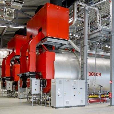 : A large industrial facility featuring multiple Bosch hot water boilers, showcasing their size and power.