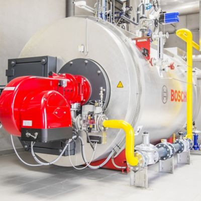 A large, industrial boiler with a red burner and yellow pipes. The boiler has a silver casing and a Bosch logo on the side.