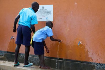 Two boys enjoying water in Uganda