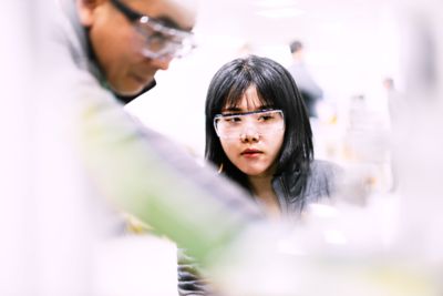 Female and male engineers with goggles