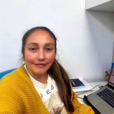 Carla Lozano sitting by her desk. 