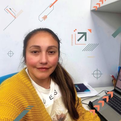 Carla Lozano sitting by her desk. 