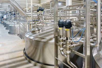 Large silver chemical blanketing tanks in a production warehouse