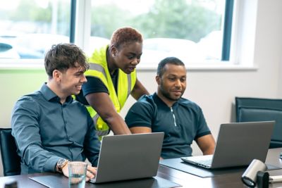 Three  diverse colleagues looking at laptop screens.