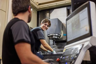 Colleagues smiling at eachother while working.