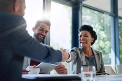 Business people shaking hands in the office for a deal.