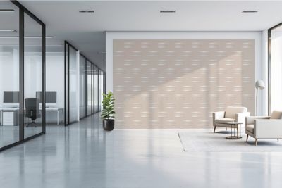 Open office space with a beige Atlas Copco logo wallpaper