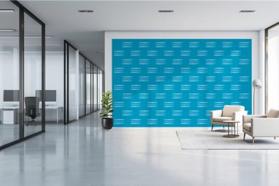 Open office space with a blue Atlas Copco logo wallpaper