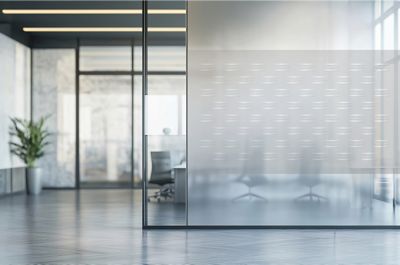 Open office space with a logo wallpaper on a glass wall