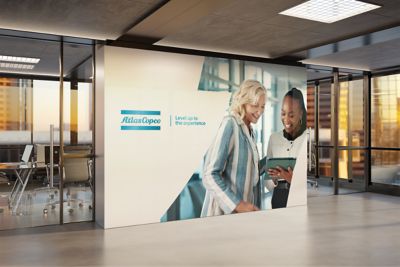 Open hallway with an Atlas Copco logo and a brand message on the wall