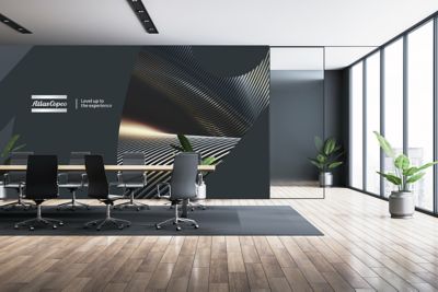 Open office space with an Atlas Cocpo and a brand message on the wall