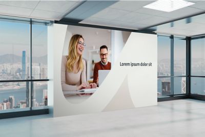 Open office space with a large Atlas Copco imagery on the wall.