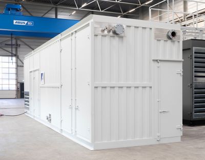 A custom-made white container with secured doors, external pipe connections, and ventilation outlets, positioned in a clean industrial setting with a visible ABUS crane in the background.
