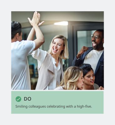 Colleagues giving hi-fives with caption: DO: Smiling colleagues celebrating with a high-five