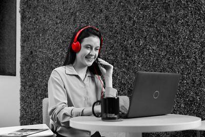 Woman with headset working on computer.